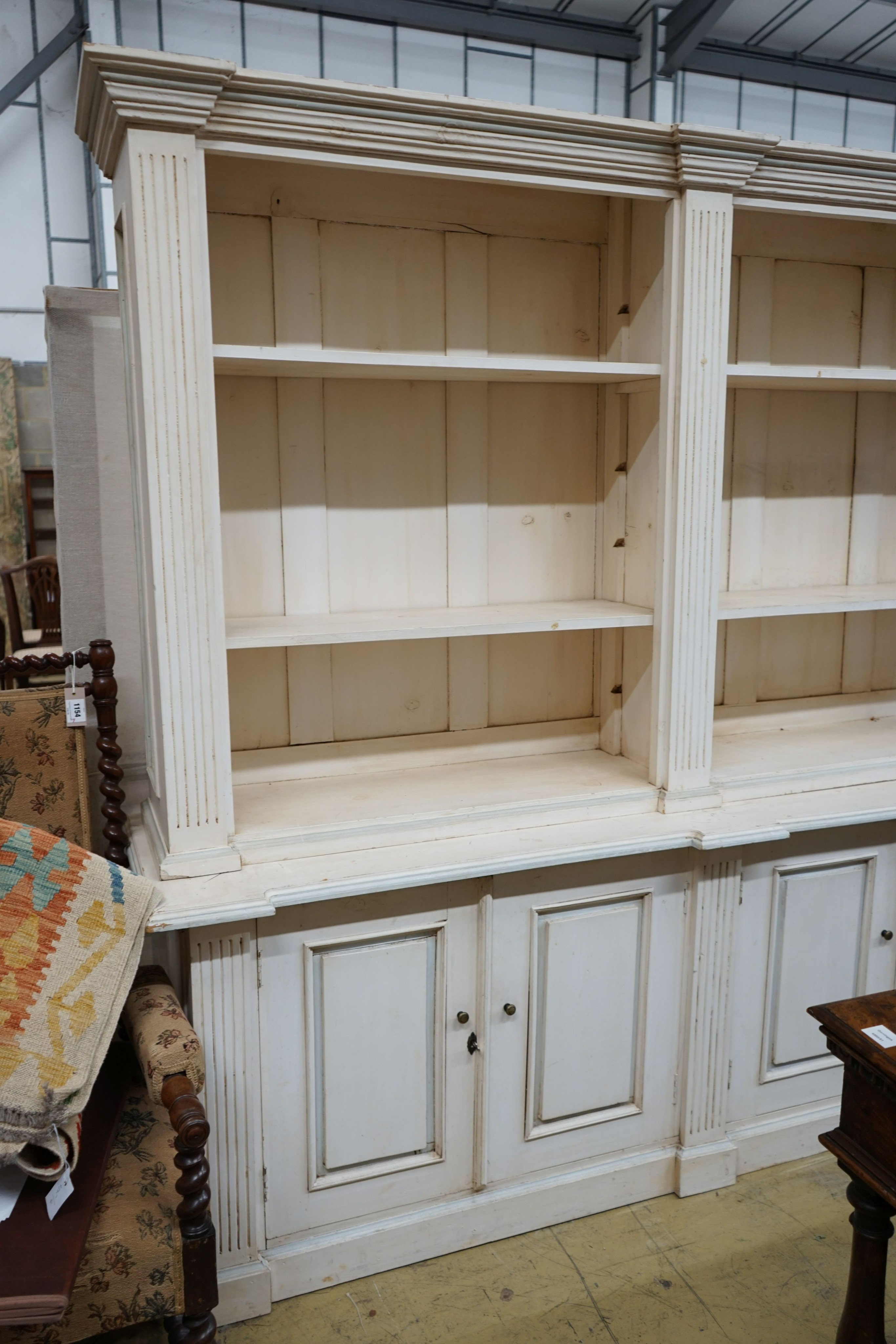 A modern George III style painted library bookcase, width 220cm depth 53cm height 208cm